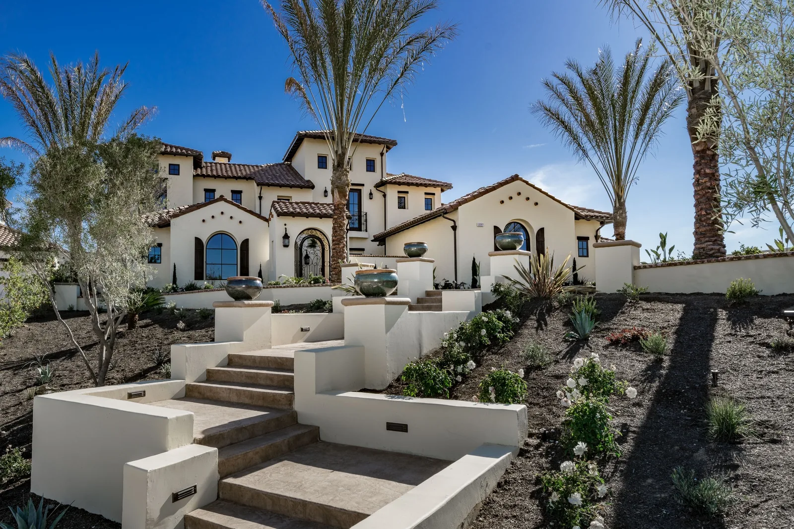 Landscaped exterior and formal entrance of Spey Valley Estate I in Fresno, California.