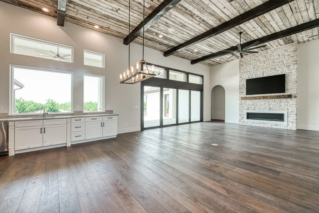 Great room with a full sliding glass wall opening to the covered patio at Ashlan Estate.