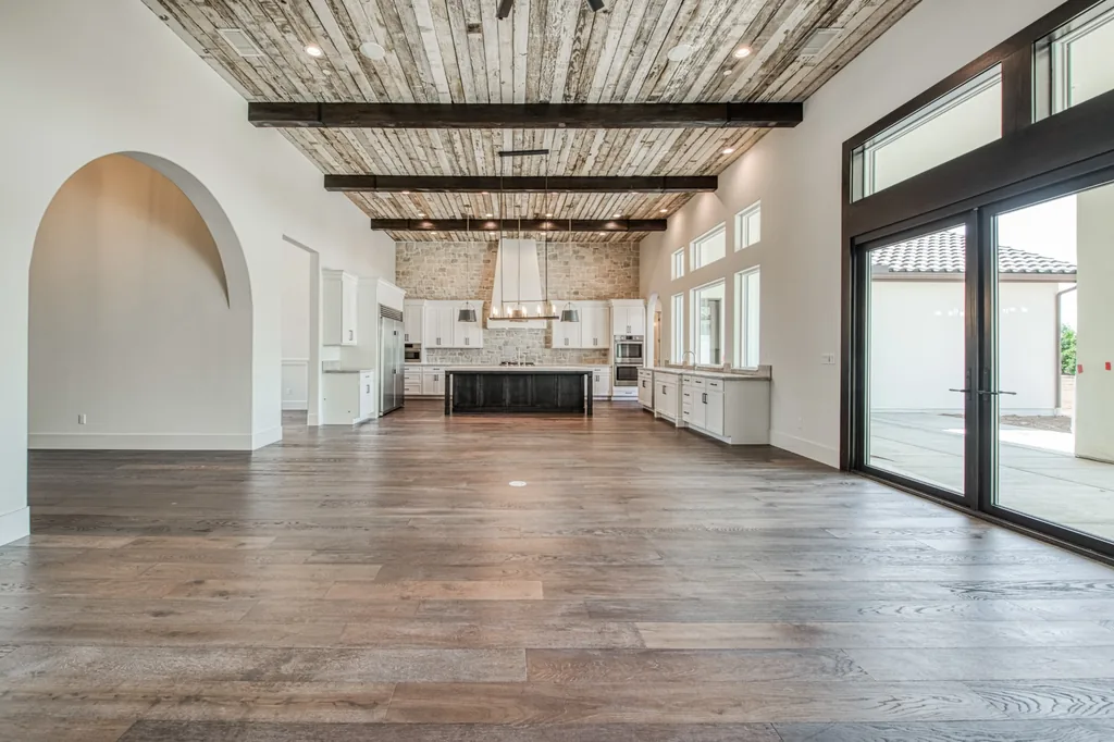 View across the great room toward the kitchen and arched openings at Ashlan Estate.