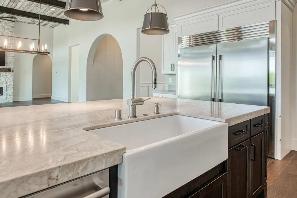 Farmhouse sink and polished fixture detail in the Ashlan Estate kitchen.