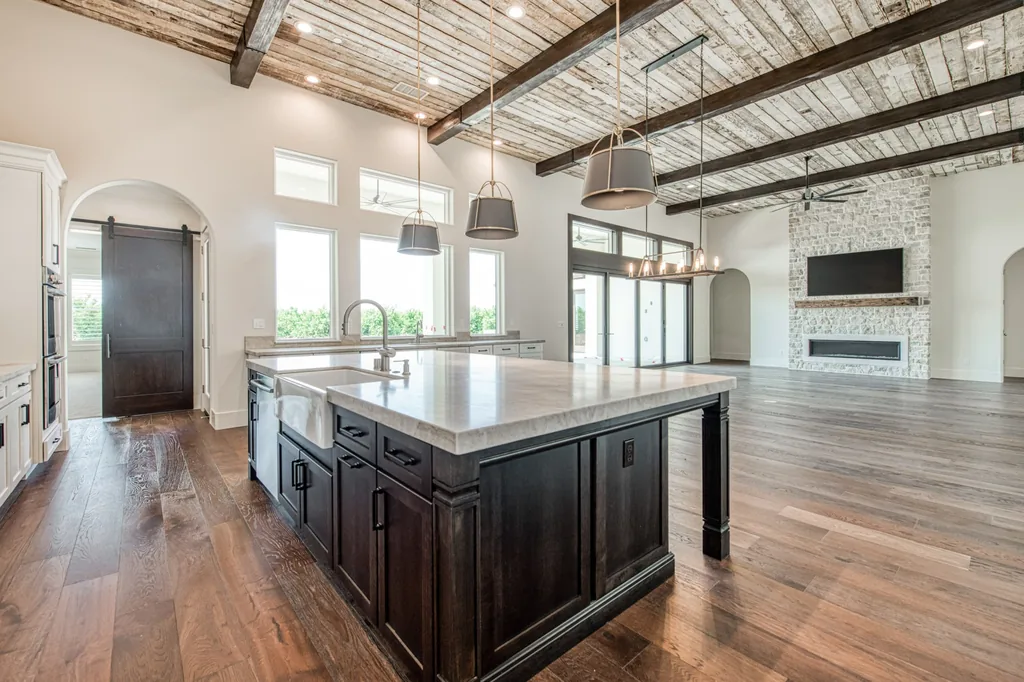 Dark stained kitchen island beneath a reclaimed wood ceiling at Ashlan Estate.