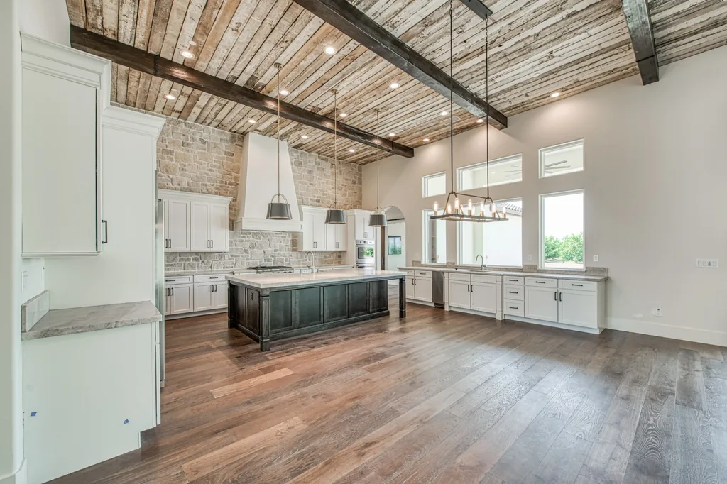 Wide view of the open-plan kitchen and living area at Ashlan Estate in Sanger, California.