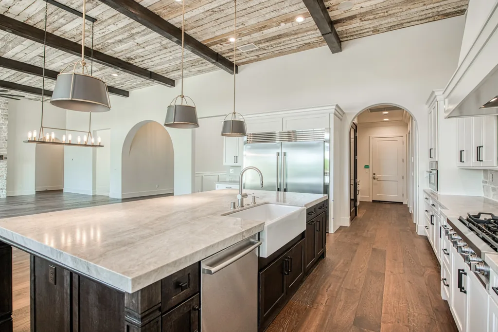 Kitchen island with prep sink and quartzite counters at Ashlan Estate.