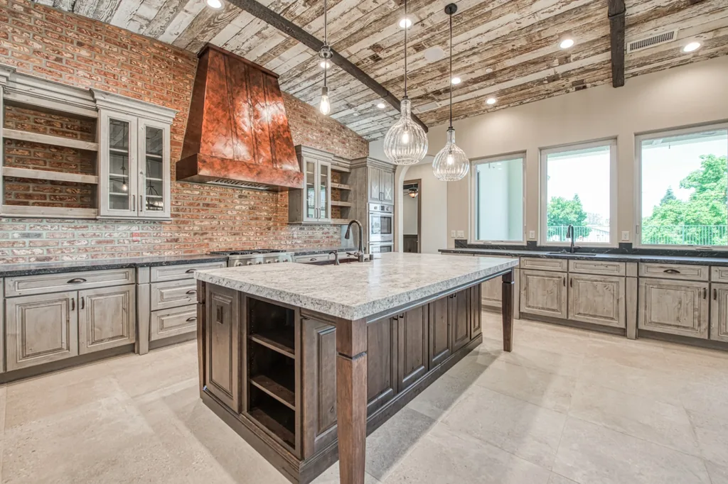 Kitchen at Devonshire Estate with a copper range hood, brick backsplash, and reclaimed wood ceiling in Fresno, California.