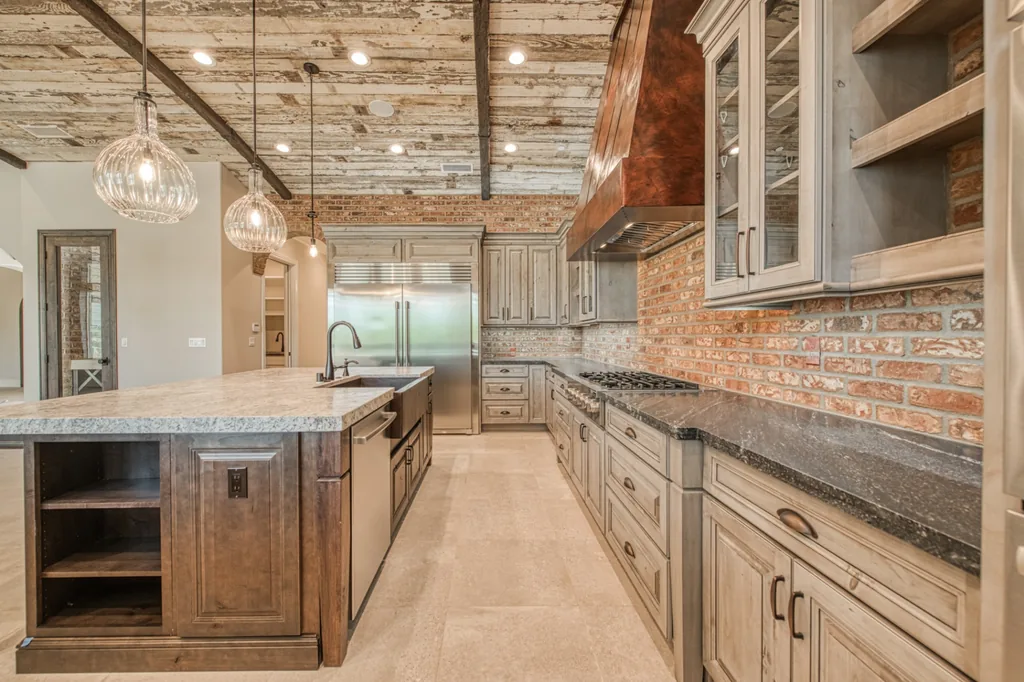 Devonshire Estate kitchen looking toward the great room beneath a reclaimed wood barrel ceiling.