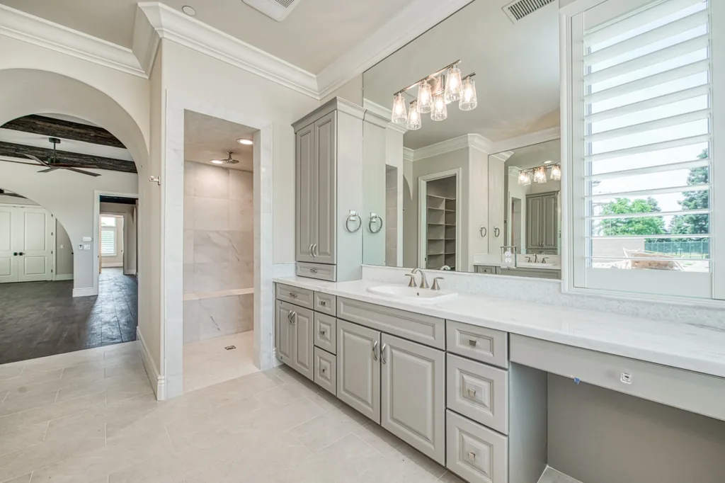 Primary bath vanity and marble walk-in shower entry at Devonshire Estate.