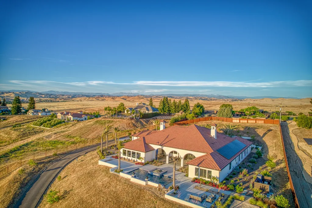 Aerial view of Friant Estate set against rolling hillside terrain in Friant, California.