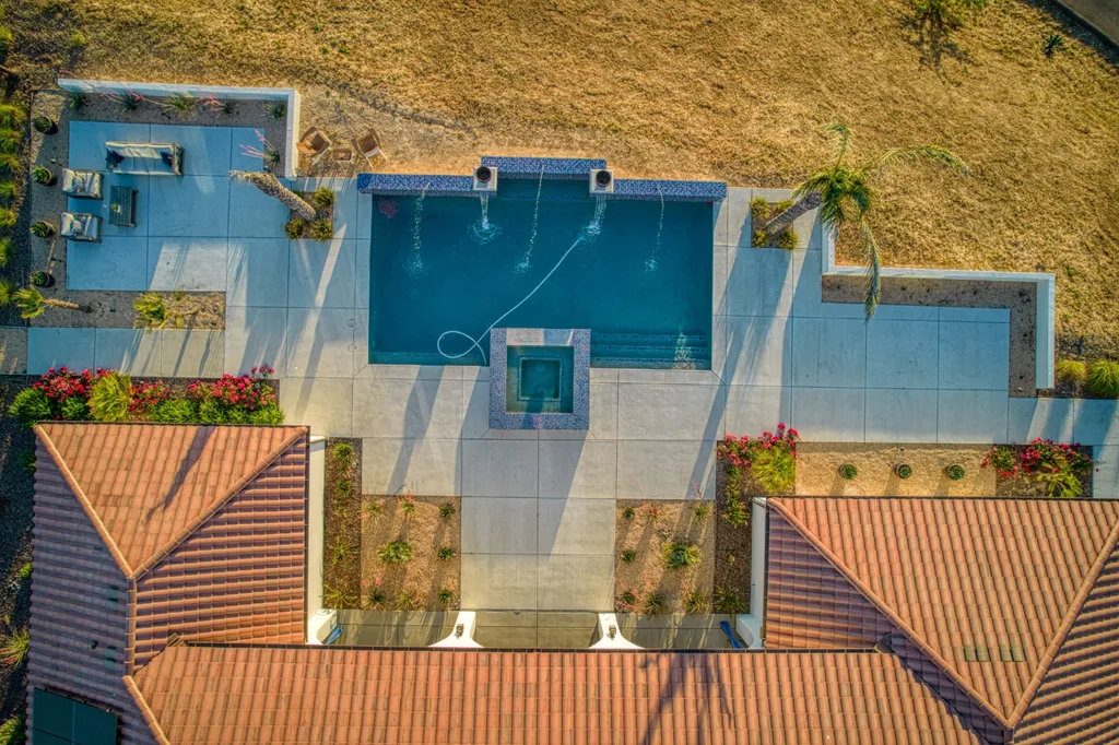Overhead aerial of the pool and spa with tile roofs framing the courtyard at Friant Estate in Friant, California.