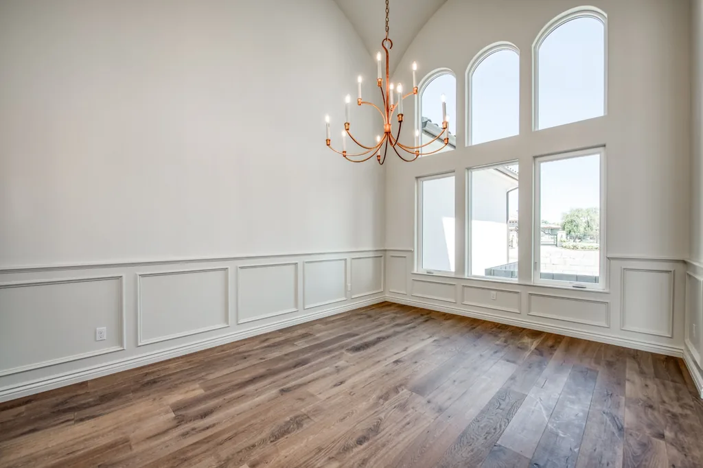 Formal room with painted wainscoting and tall arched windows at Kings Estate.