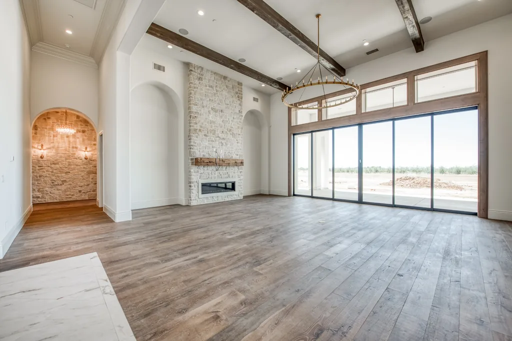 Great room with stone fireplace and wide sliding glass doors at Kings Estate.