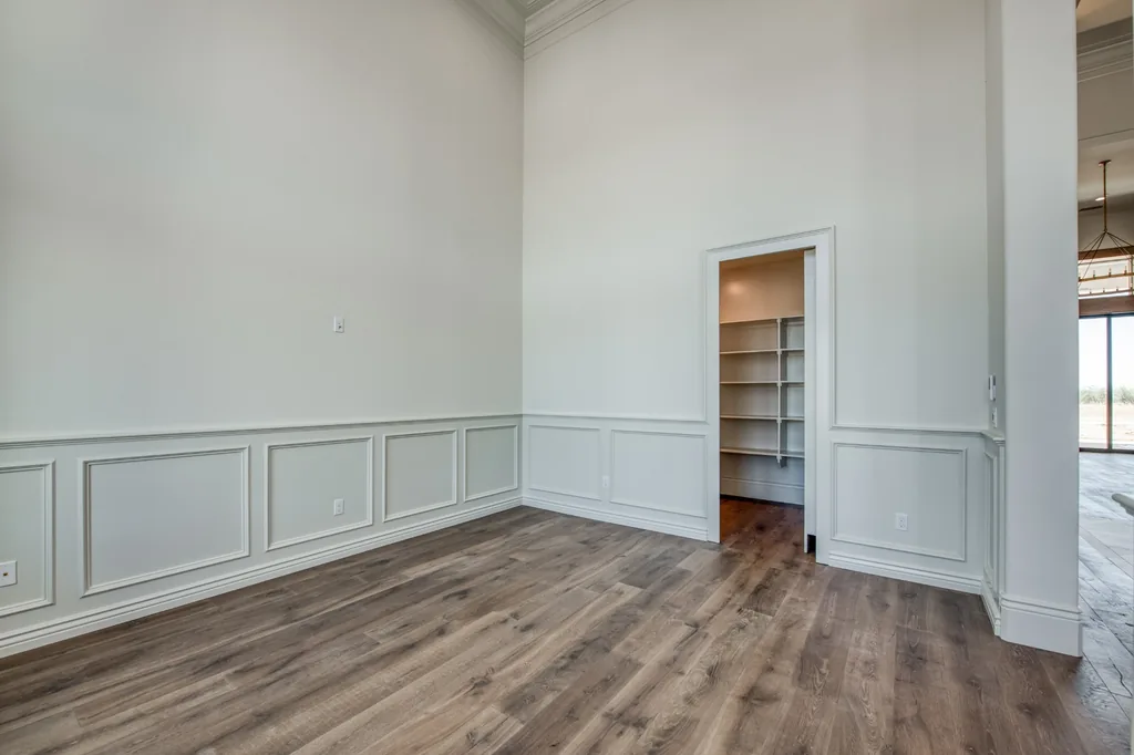 Room with painted wainscoting and open doorway at Kings Estate.