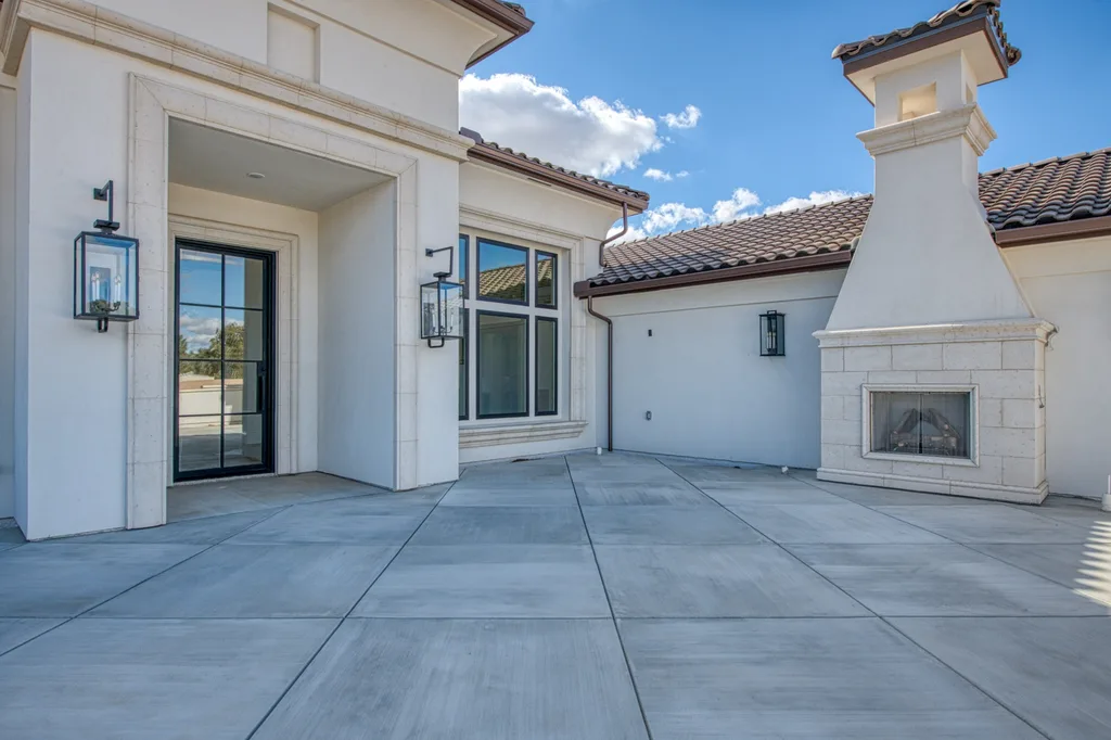 Front courtyard with stone outdoor fireplace at Queens Estate.