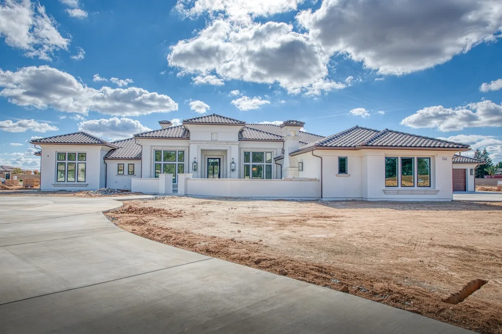 Wide view of the front elevation and entry courtyard wall at Queens Estate in Clovis, California.