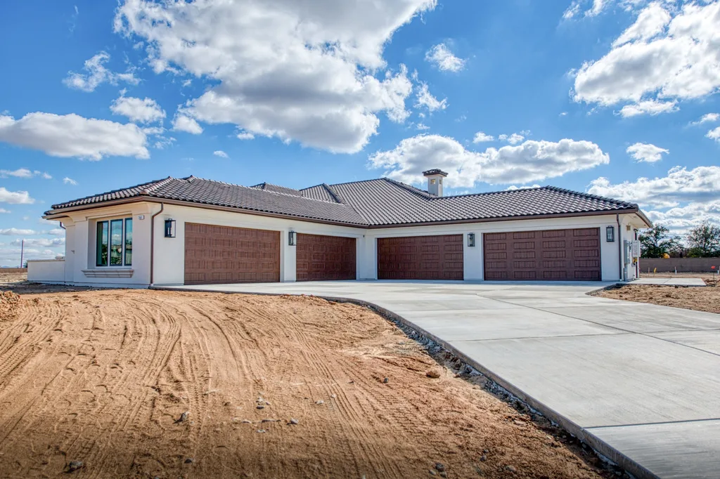 Four-car garage elevation with wood-grain doors at Queens Estate.