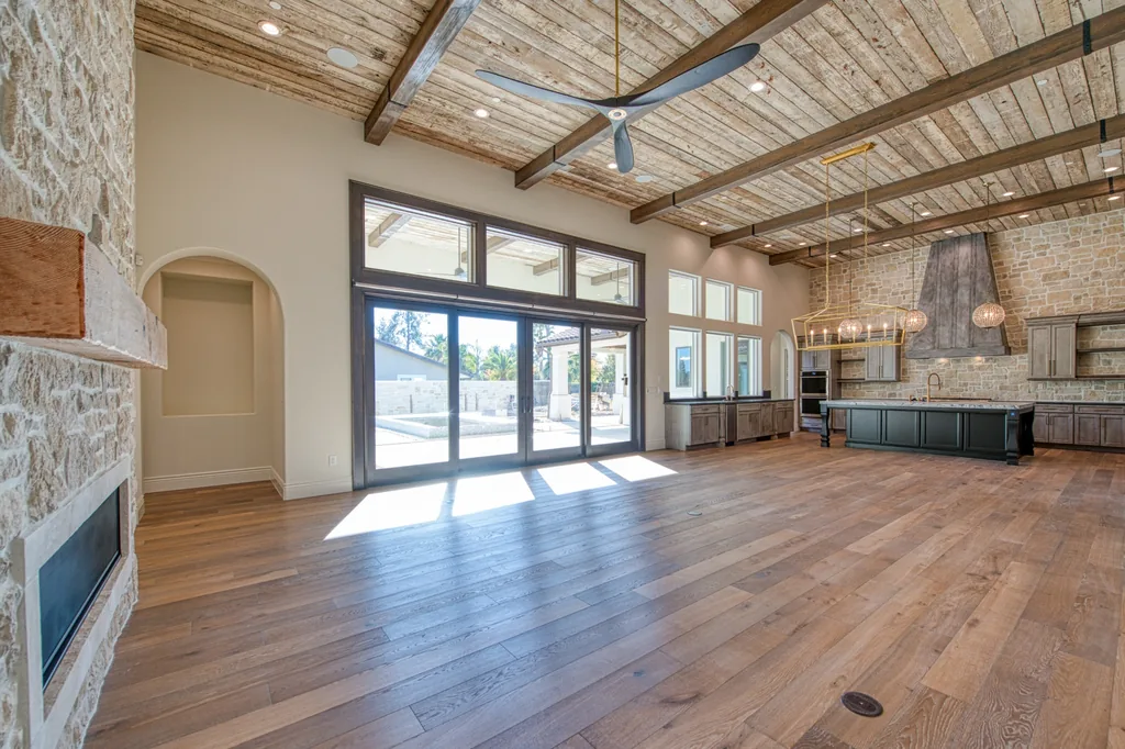 Great room with reclaimed wood plank ceiling and heavy timber beams.