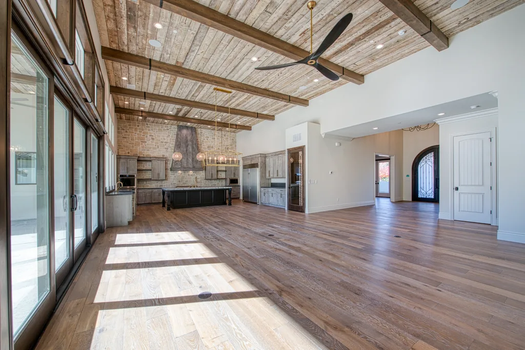 Great room open plan with multi-panel sliding glass doors to the rear grounds.