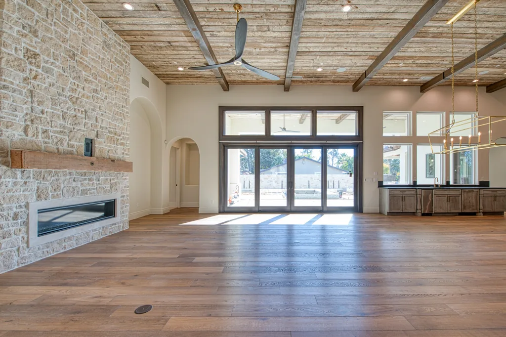 Great room with floor-to-ceiling stone fireplace and linear firebox.