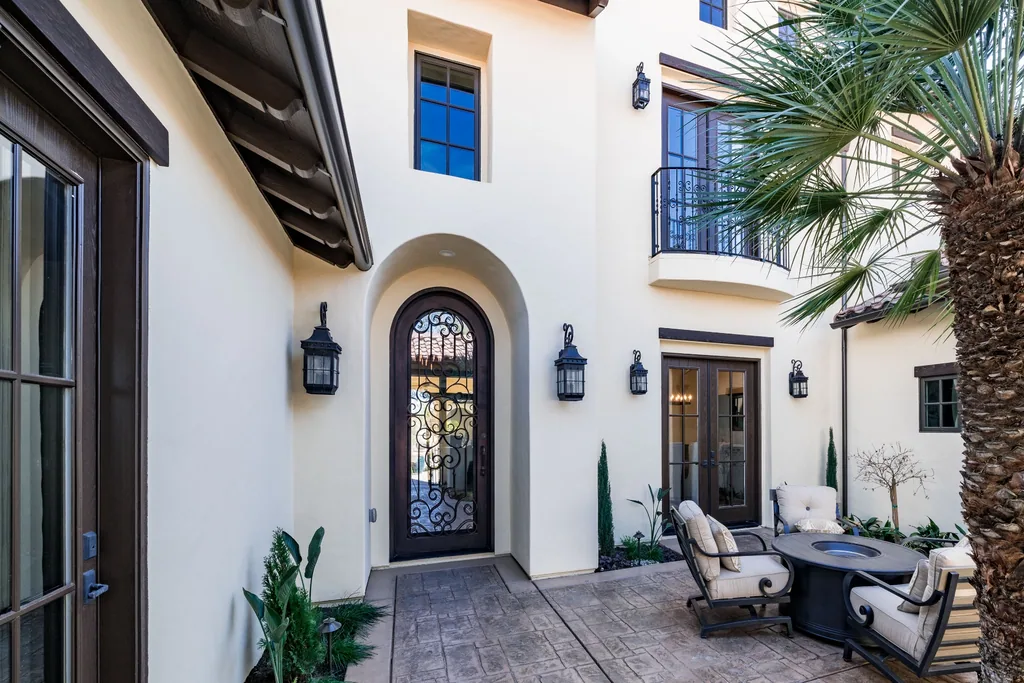 Entry courtyard with arched iron front door and stucco walls at Spey Valley Estate I.