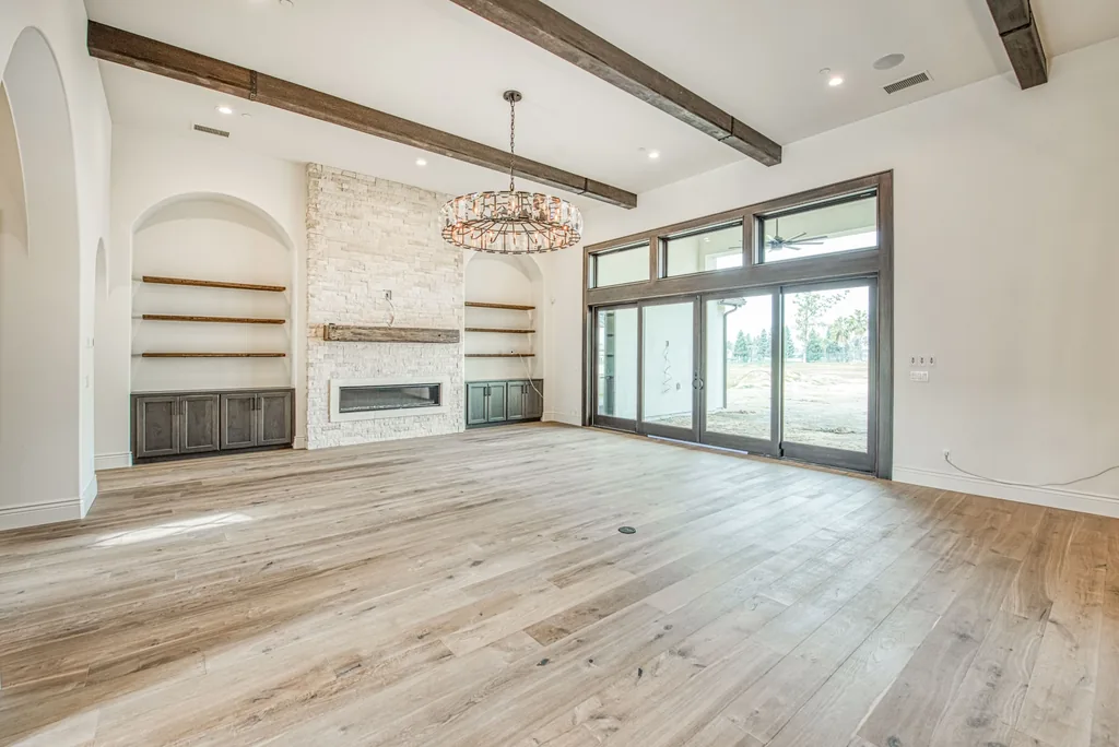 Great room fireplace wall beside multi-panel sliding glass doors.