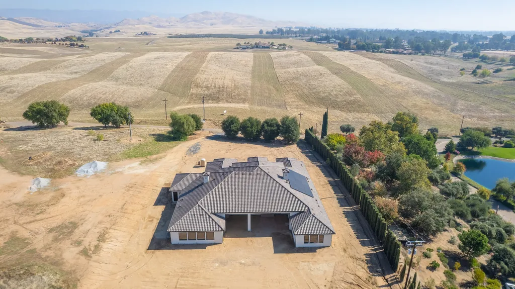 Wide aerial view of Willow Bluff Estate set against rolling hills and open pasture.
