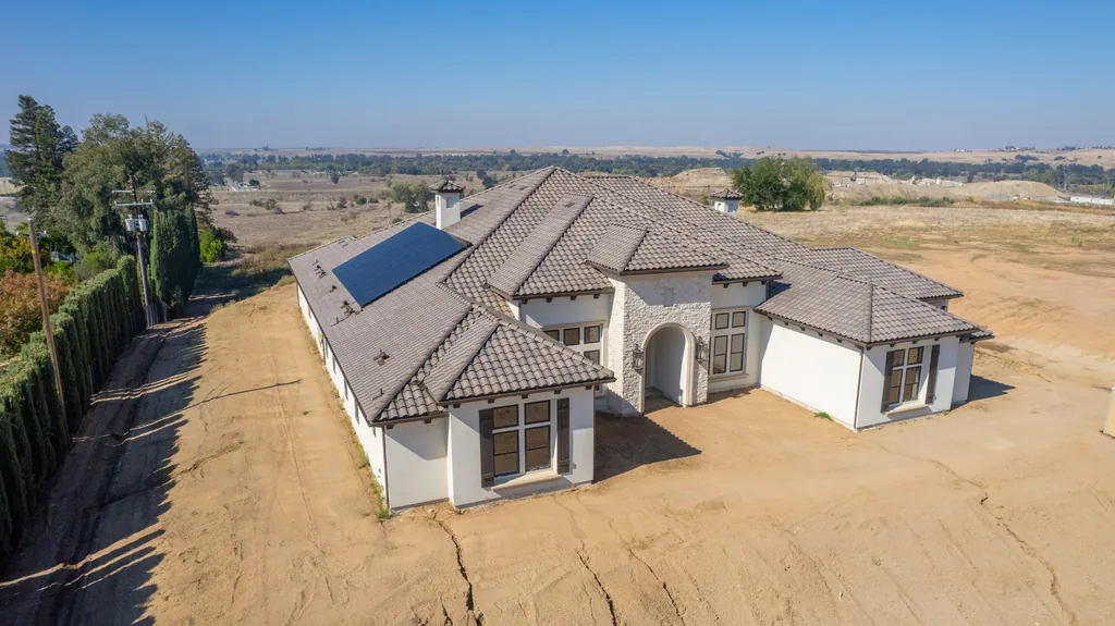 Aerial view of Willow Bluff Estate showing the stone-clad arched entry and tile roofline.
