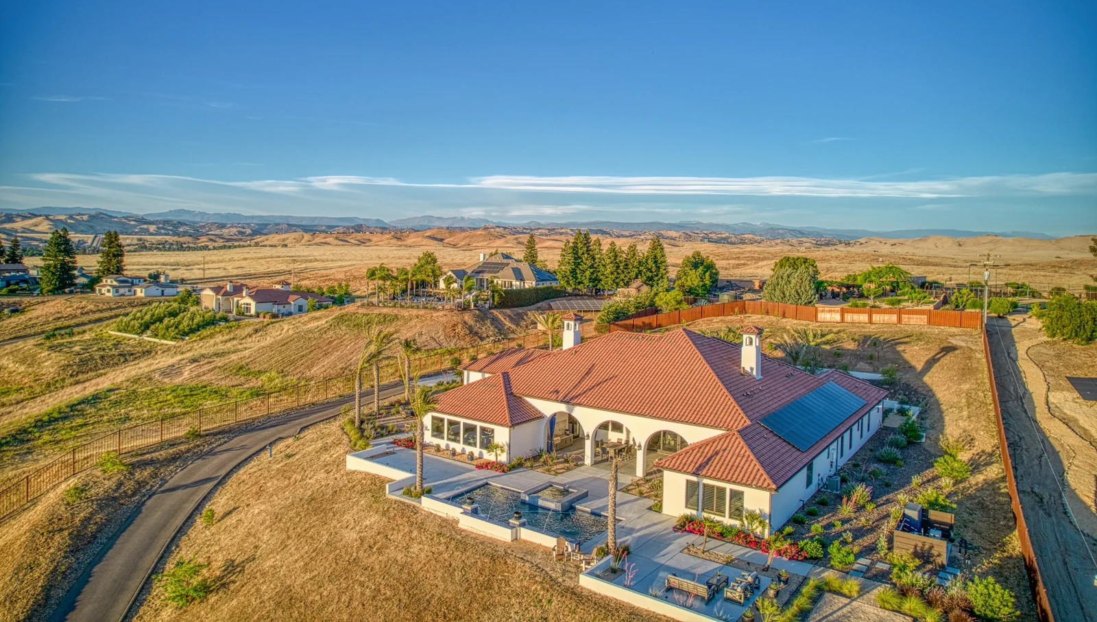 Aerial view of a custom home and surrounding homesite in California’s Central Valley.